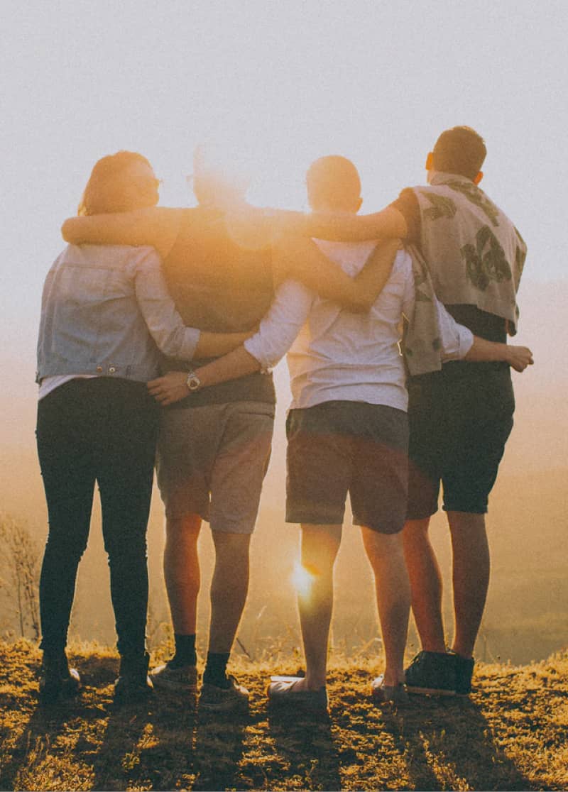 four people embracing each other